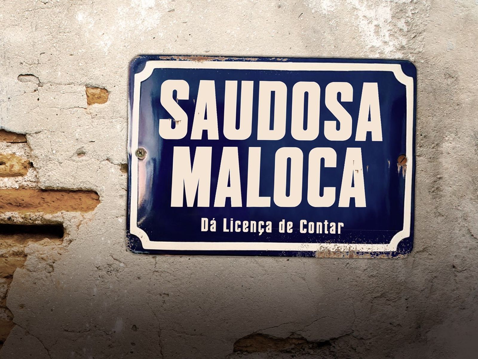 Placa-título esmaltada: Saudosa Maloca, Dá Licença de Contar, pregada num muro de reboco descascado